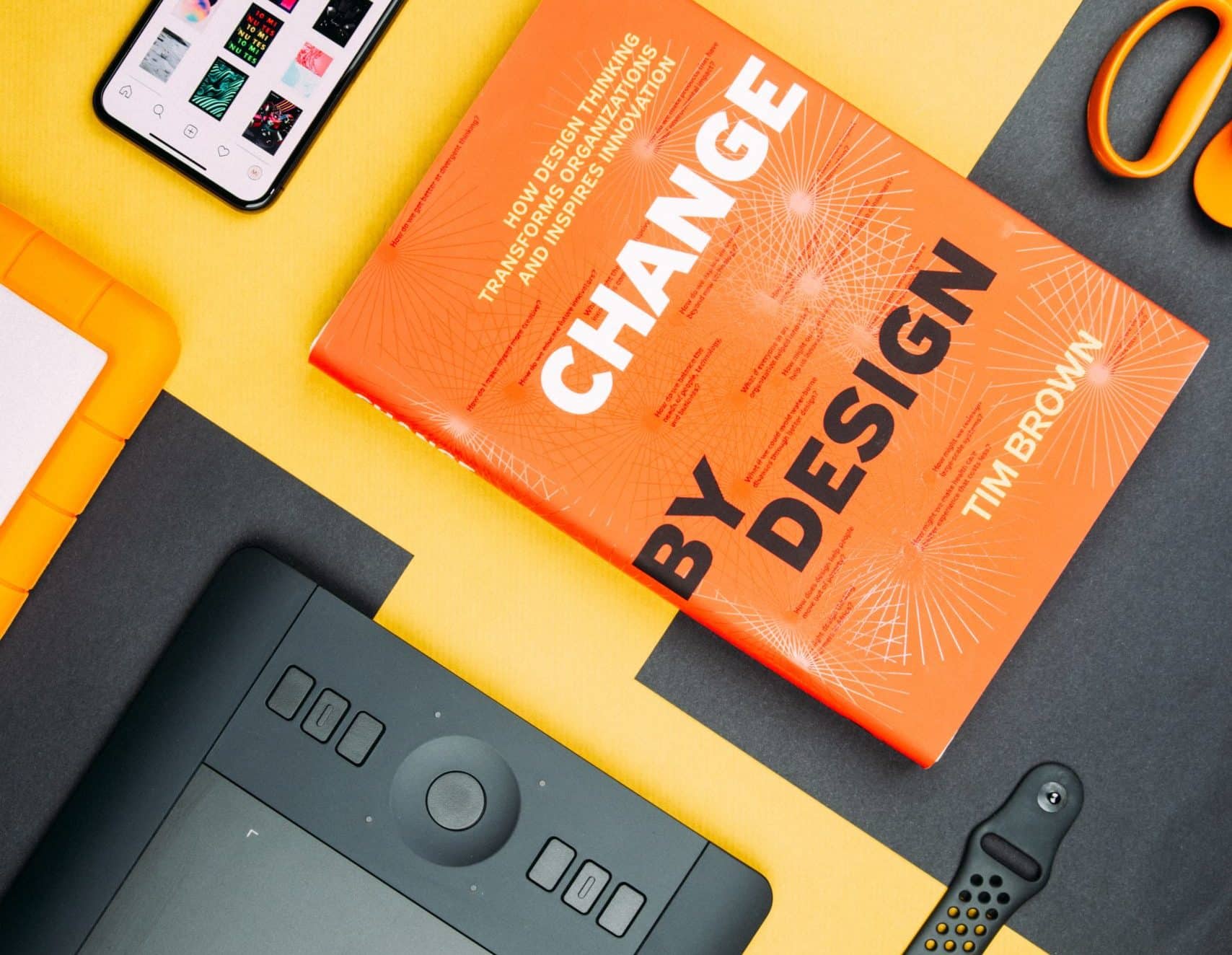 Change by Design by Tim Brown book beside smartphone